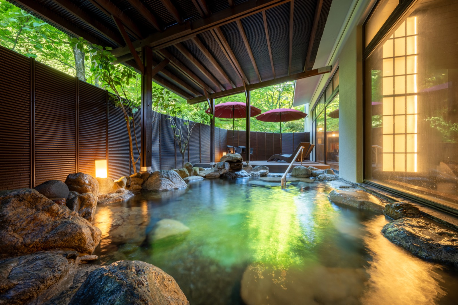 Open-air hot spring bath surrounded by greenery